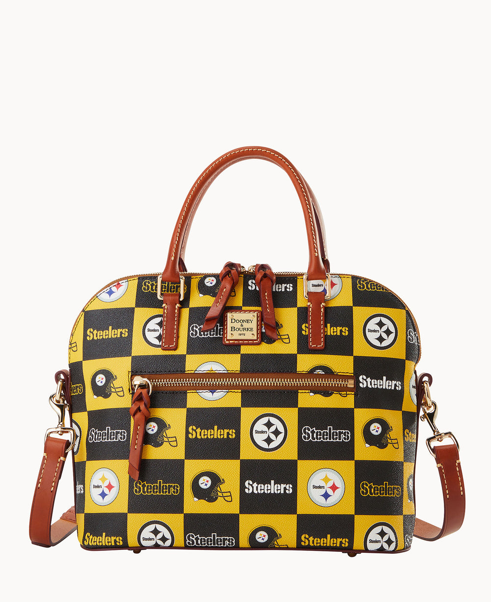 A Dooney & Bourke satchel handbag featuring a yellow and black checkered pattern with the Pittsburgh Steelers logo and name. The bag has brown leather handles, trim, and detachable strap.