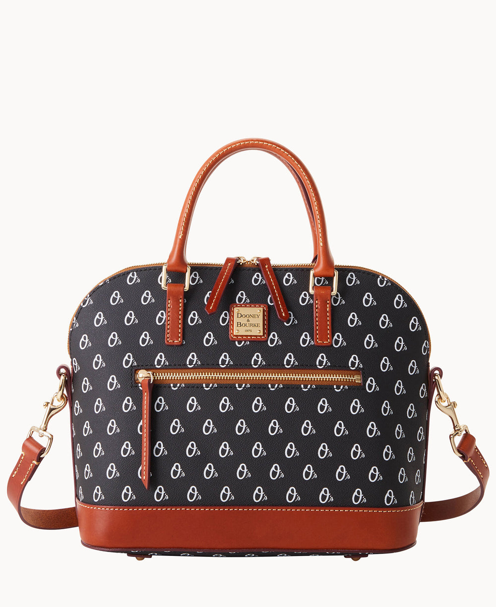 A black Dooney & Bourke handbag with brown leather handles, trim, and detachable shoulder strap. The bag features a repeating white logo pattern, a front zipper pocket, gold hardware, and a rectangular logo plate.