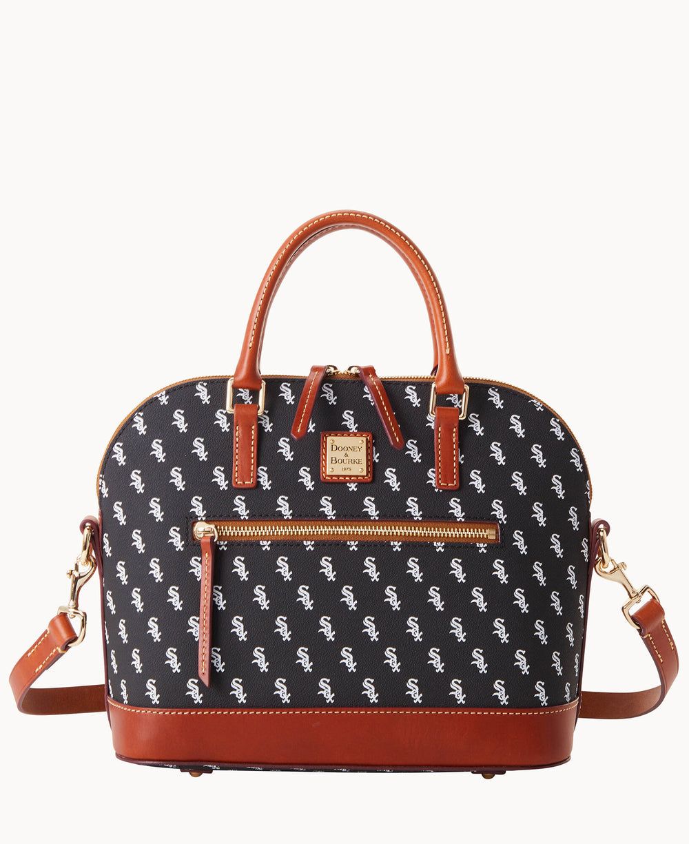 A black and white dome-shaped handbag with brown leather handles, trim, and strap. The bag features a repeating white Chicago White Sox logo pattern and a front pocket with a gold Dooney & Bourke label.