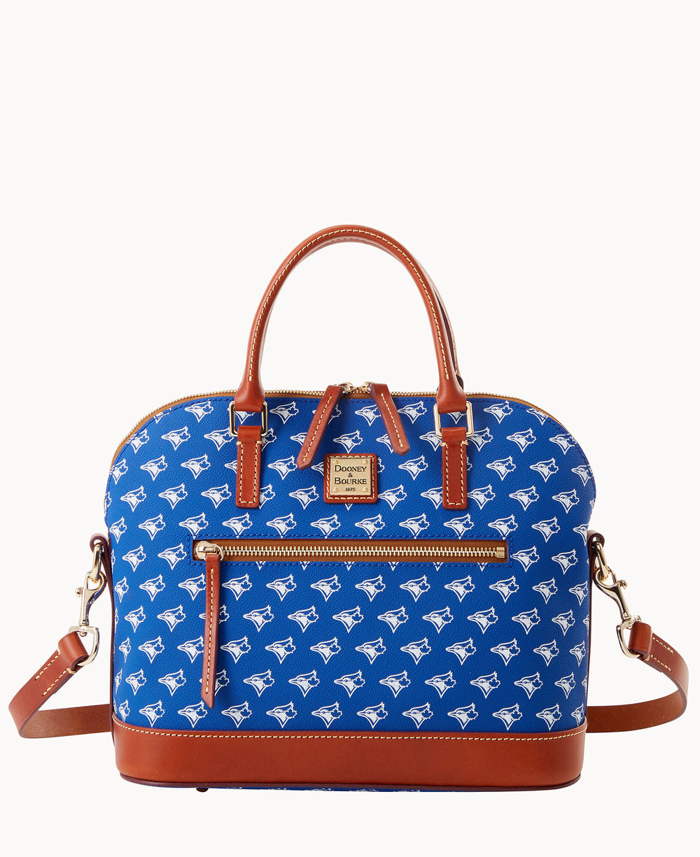 A blue Dooney & Bourke satchel bag with brown leather handles and trim, an adjustable shoulder strap, and a repeating white Toronto Blue Jays logo pattern. There is an exterior zip pocket on the front.