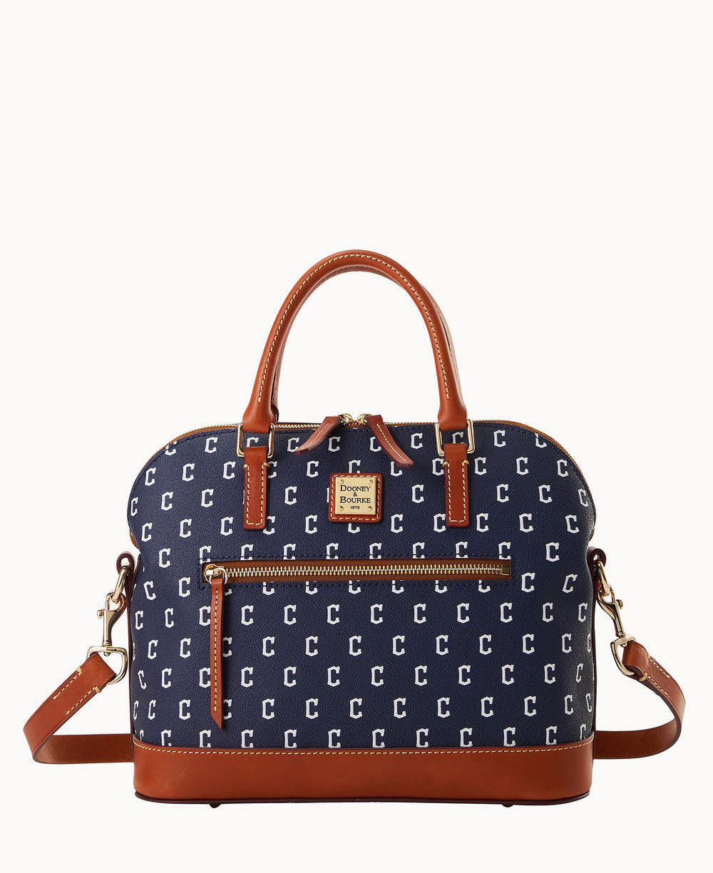 A navy blue handbag with brown leather handles and trim, featuring a repeating pattern of white letter Cs, a front zip pocket, and a detachable shoulder strap.