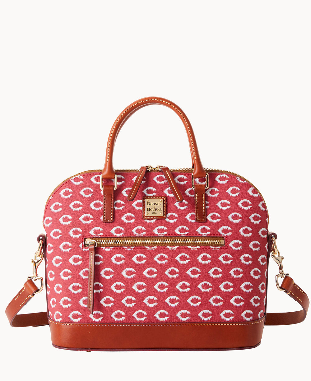 A red Dooney & Bourke satchel handbag with brown leather trim, gold hardware, and an all-over repeating white Cincinnati Reds â€œCâ€ logo pattern. The bag has a top handle and a detachable shoulder strap.