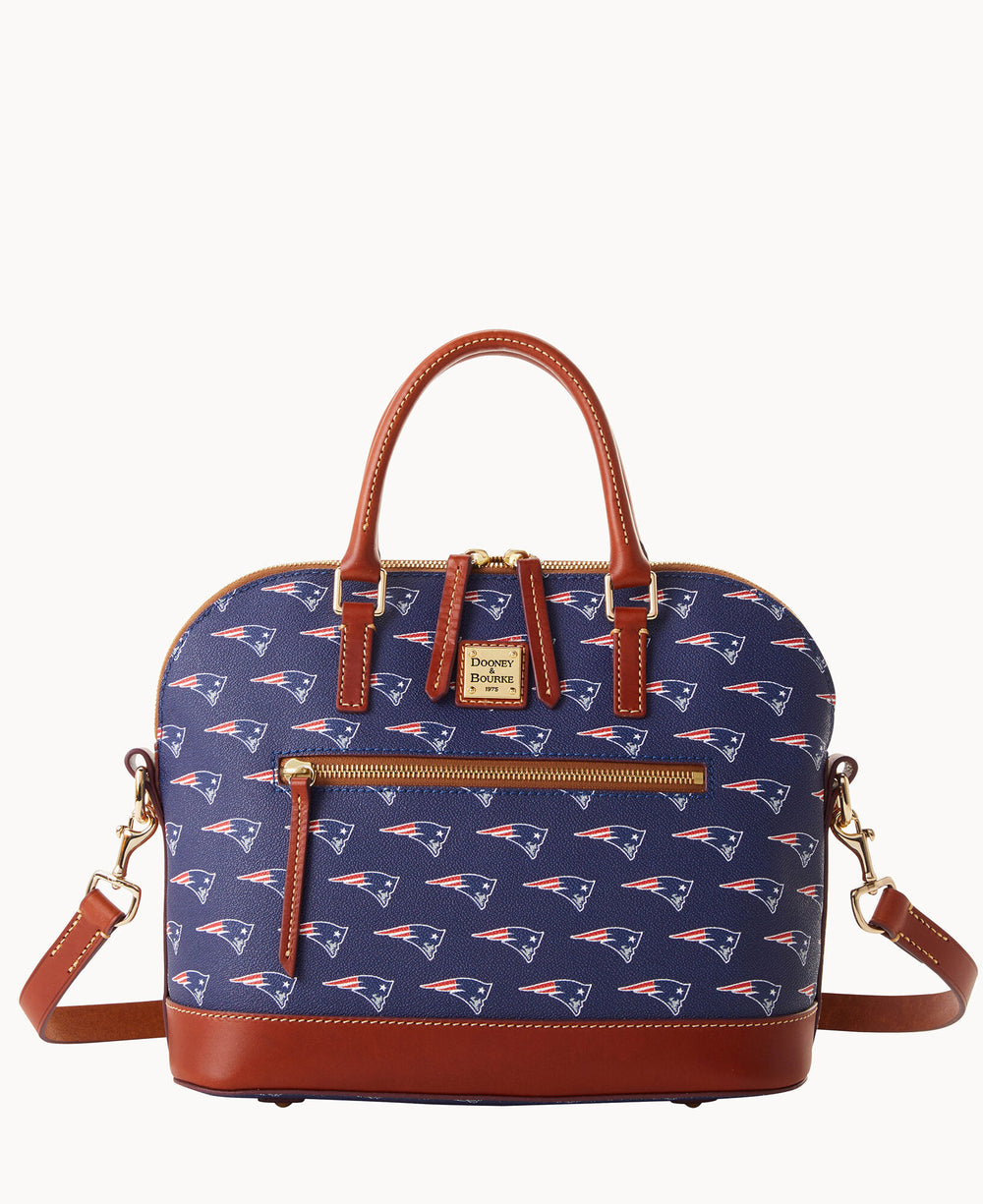 A navy blue handbag with brown leather handles and accents, featuring a repeating New England Patriots logo pattern, a front zipper pocket, and a detachable shoulder strap.