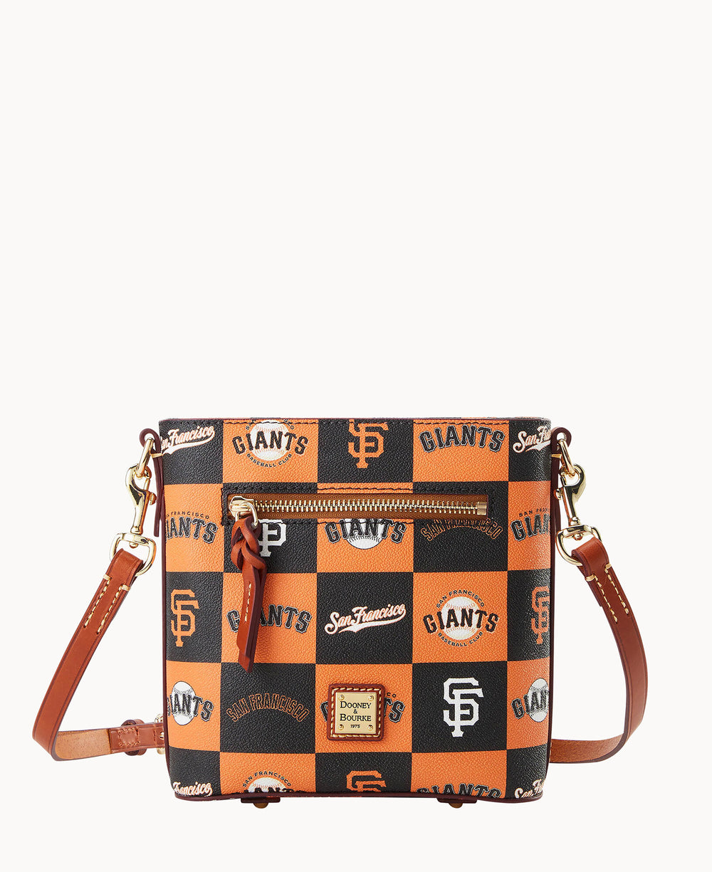 A crossbody bag with a San Francisco Giants baseball team design in orange, black, and white checkered pattern. The bag has a front zipper pocket, gold-tone hardware, and an adjustable brown leather strap.
