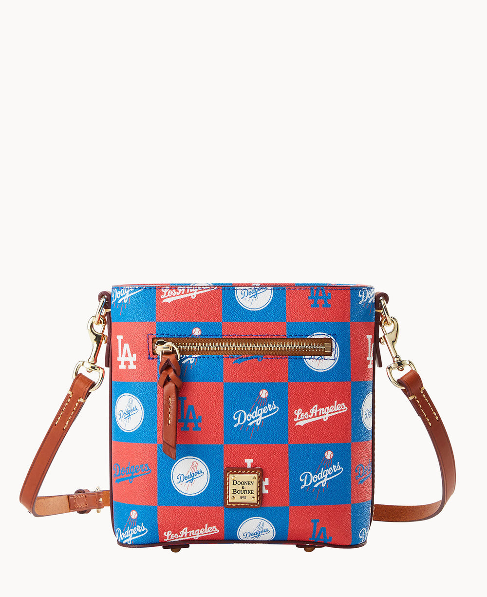 A small crossbody bag with brown leather straps and gold hardware, featuring a red and blue checkered pattern with Los Angeles Dodgers logos and text.