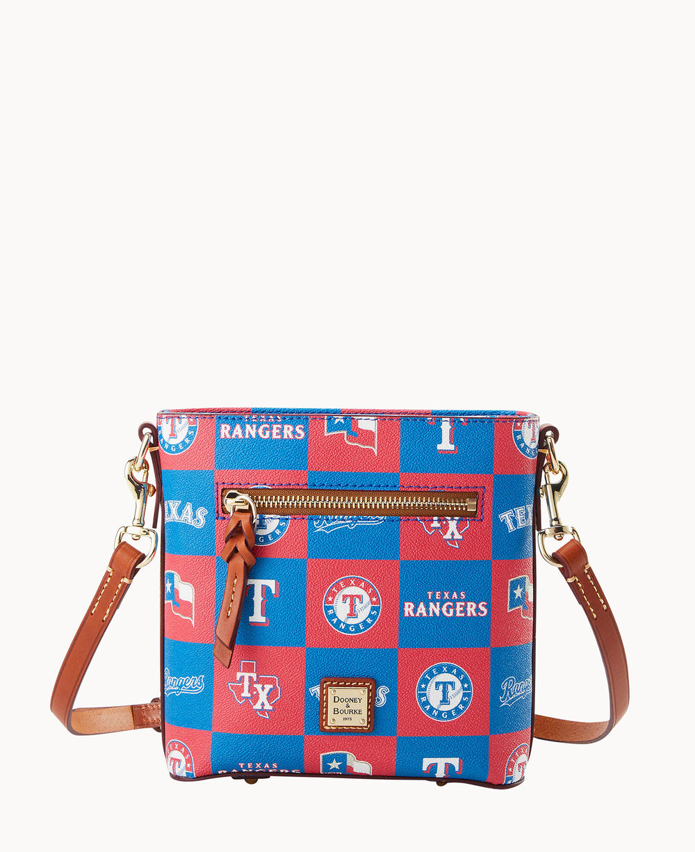 A crossbody bag featuring a blue and red Texas Rangers patchwork design, brown leather straps and trim, a front zipper pocket, and a Dooney & Bourke logo patch at the bottom.
