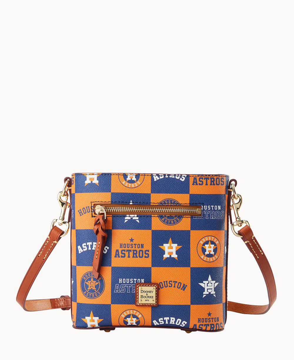 A crossbody bag with a brown leather strap featuring a blue and orange checkered pattern with Houston Astros logos and text, plus a small front zip pocket and gold hardware.