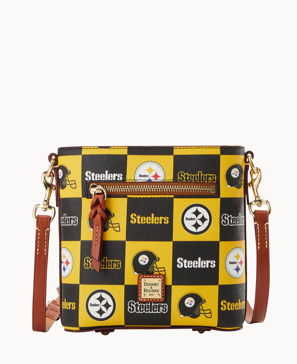 A small crossbody bag with a yellow and black checkered pattern featuring the Pittsburgh Steelers logo, football helmets, and the word Steelers, with brown leather accents and a front zipper pocket.