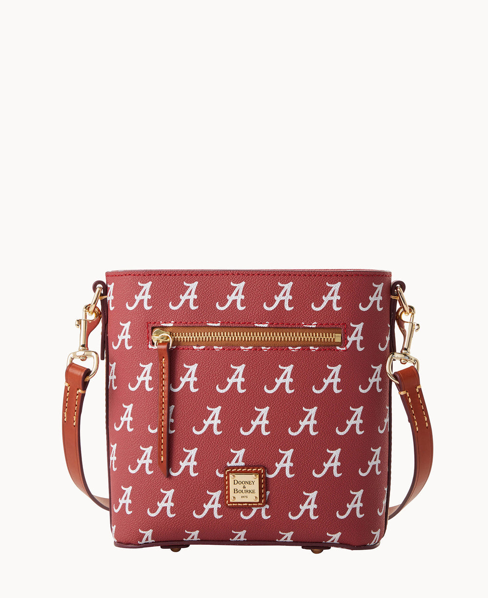 A maroon crossbody bag with a gold zipper pocket and brown leather strap, featuring a repeating white A pattern and a small Dooney & Bourke logo plate on the front.