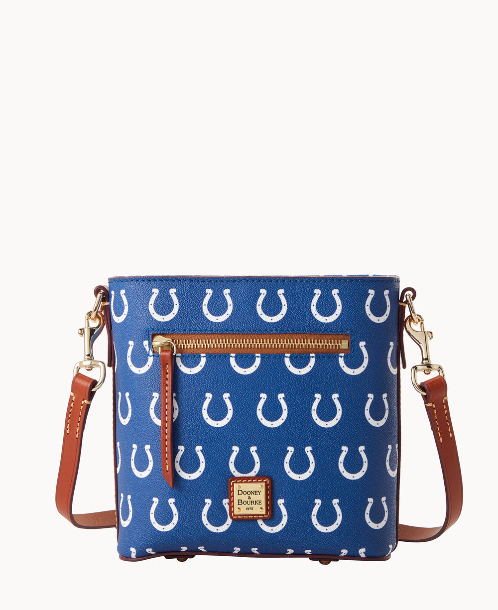 A blue crossbody bag with brown leather straps, gold hardware, a front zip pocket, and a pattern of white horseshoes. The Dooney & Bourke logo patch is displayed on the front.
