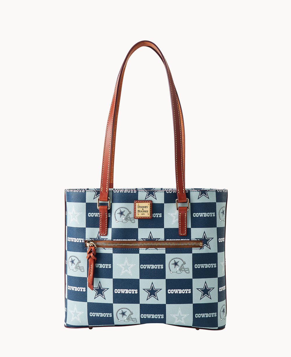 A blue and white checkered tote bag with brown leather handles, featuring the Dallas Cowboys logo and the word COWBOYS in alternating squares, plus a front zipper pocket.