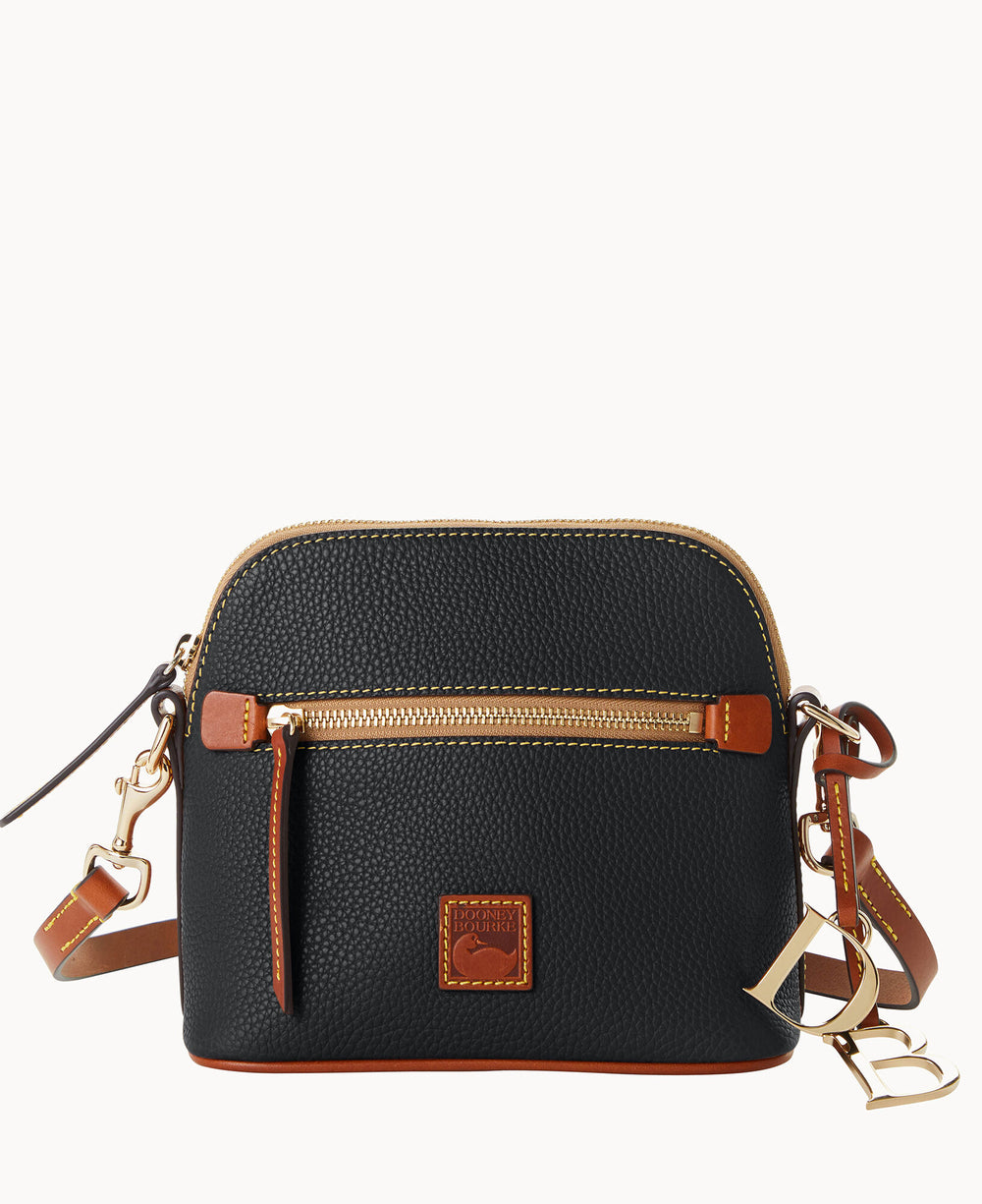 A small black leather crossbody bag with brown trim, a front zip pocket, gold-tone hardware, and an adjustable strap. The bag features a decorative keychain and a small logo patch on the front.