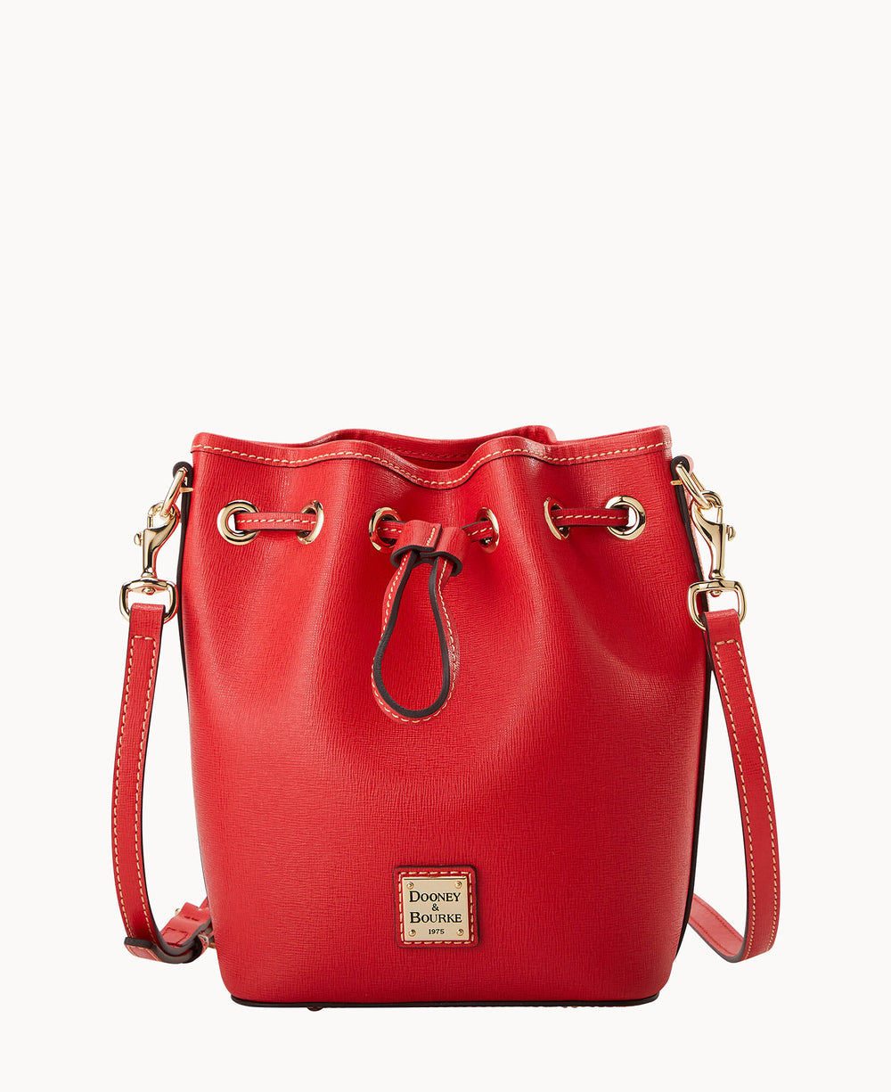 A red leather bucket bag with gold-tone hardware, a drawstring closure, and an adjustable shoulder strap. The front features a small square Dooney & Bourke logo plaque.