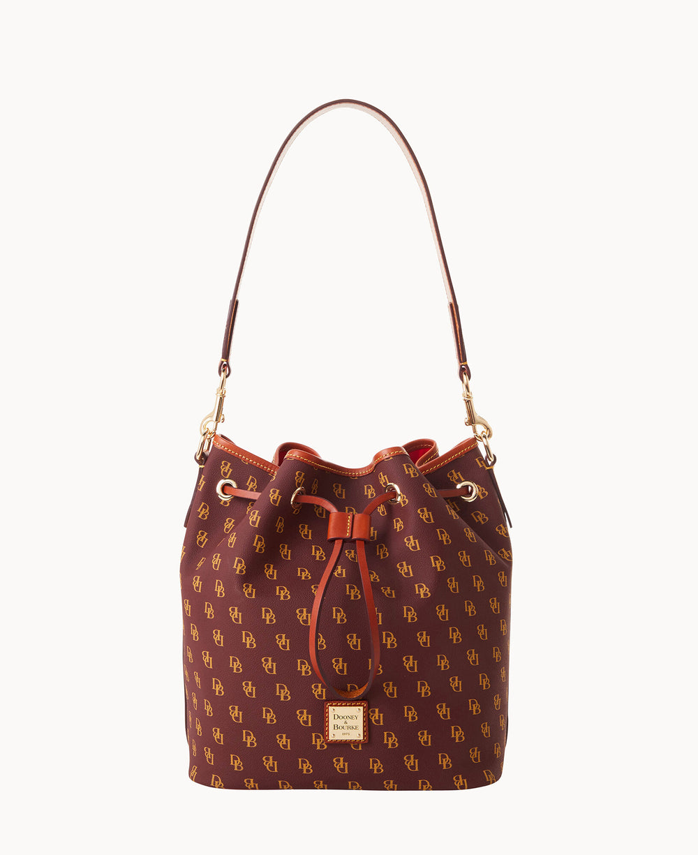 A burgundy drawstring bucket bag with an all-over yellow DB monogram pattern, gold hardware, and a matching shoulder strap. The bag features a leather trim and a front metal logo plate.