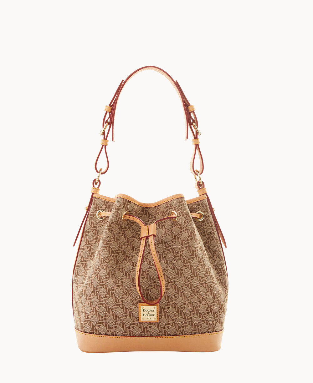 A tan and brown bucket bag with a drawstring closure, decorated with a repeating logo pattern, leather trim, and a top handle. The brands logo tag is on the front.