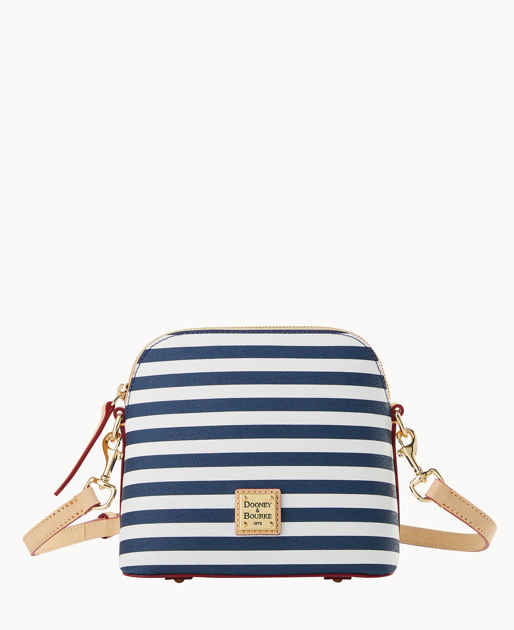 A small crossbody bag with navy blue and white horizontal stripes, gold-tone hardware, tan leather strap and trim, and a gold Dooney & Bourke logo plaque on the front.