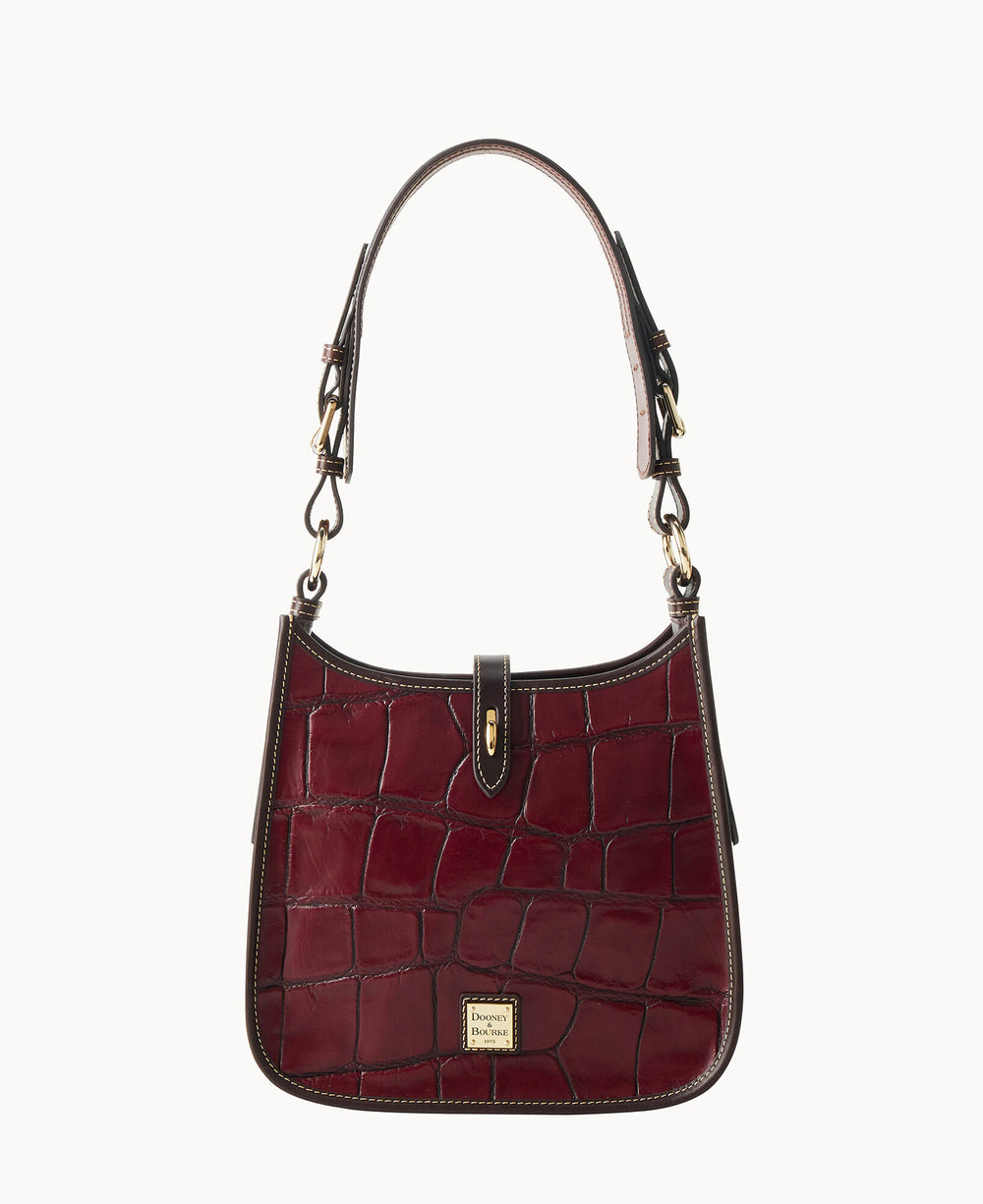 A burgundy, crocodile-embossed leather handbag with a short handle, gold hardware, and a small gold label on the front, set against a plain white background.