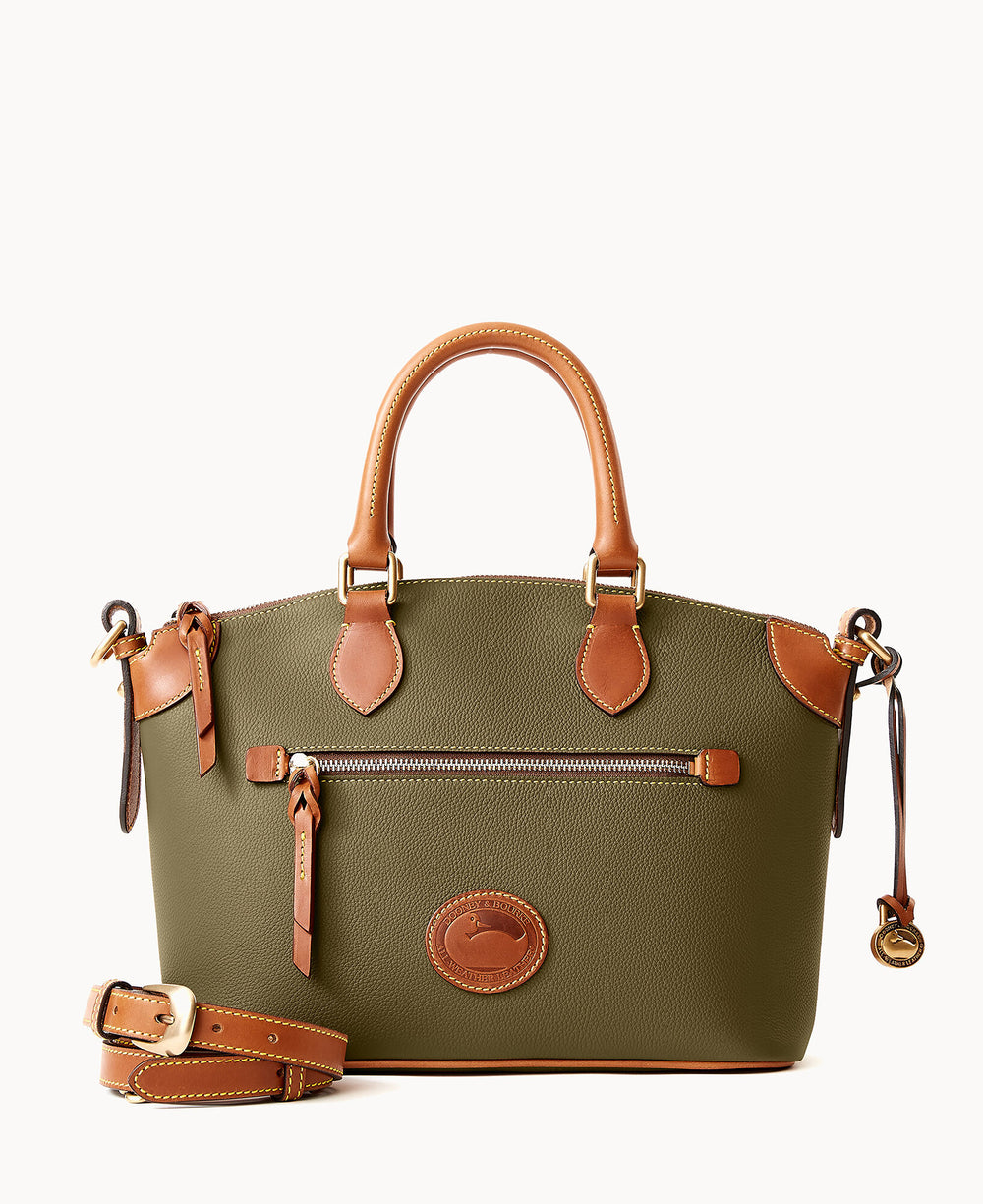 Olive-green leather handbag with tan leather handles and trim, a front zippered pocket, and an attached matching shoulder strap placed in front. The bag has gold-tone hardware and a circular logo patch on the front.