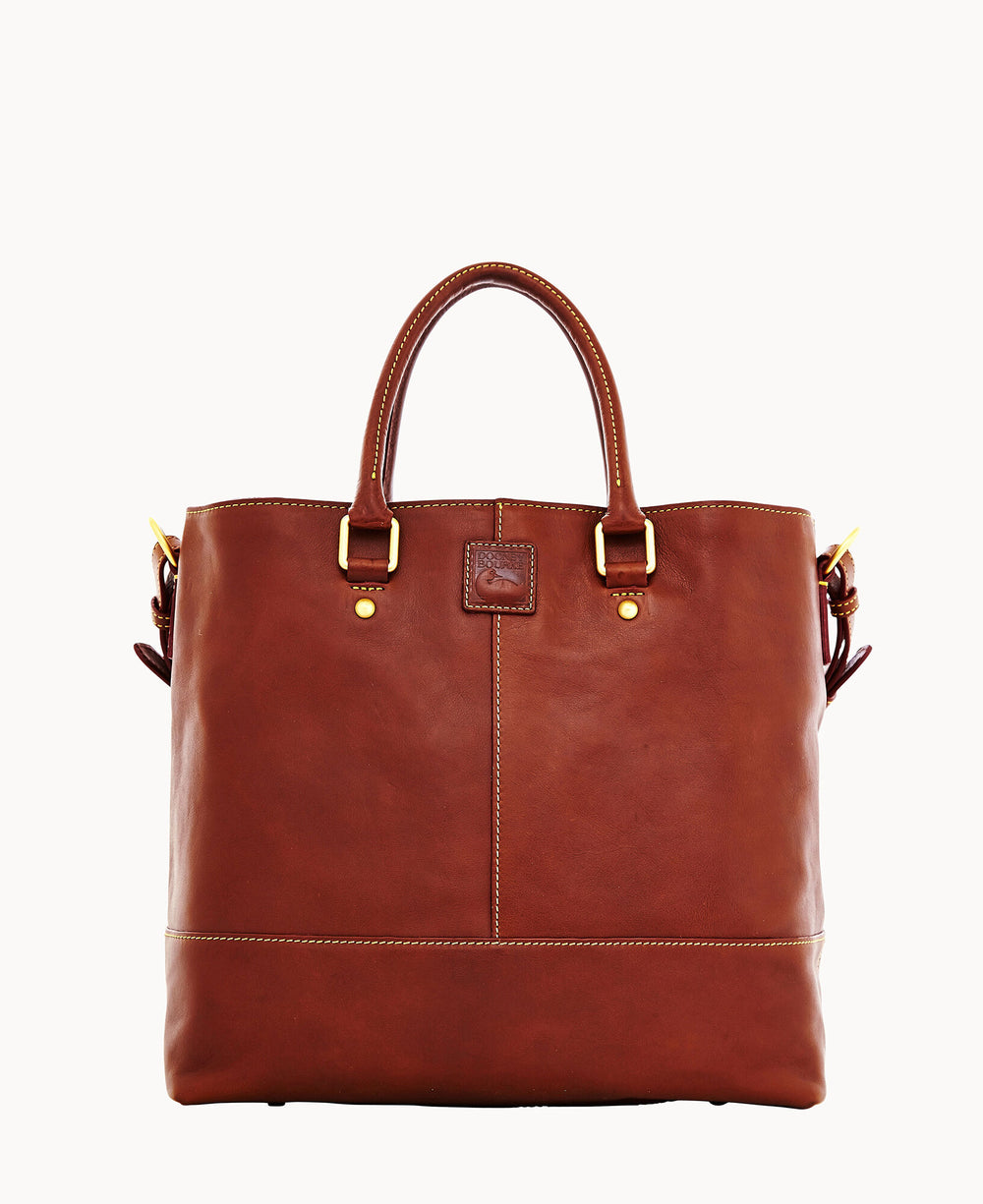 A brown leather tote bag with two handles, gold-tone hardware, and visible stitching. The bag has a structured shape and a small leather patch on the front.