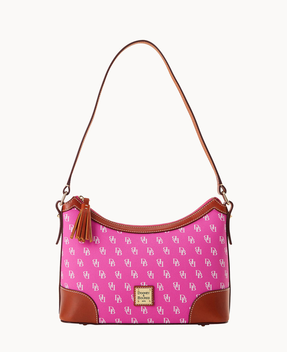 Bright pink shoulder bag featuring white Dooney & Bourke DB logo pattern with brown leather corners