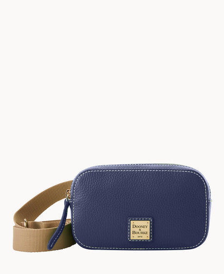 A small, rectangular, navy blue leather crossbody bag with a tan adjustable strap and a gold Dooney & Bourke logo plate on the front. The bag has white stitching and a zipper closure.
