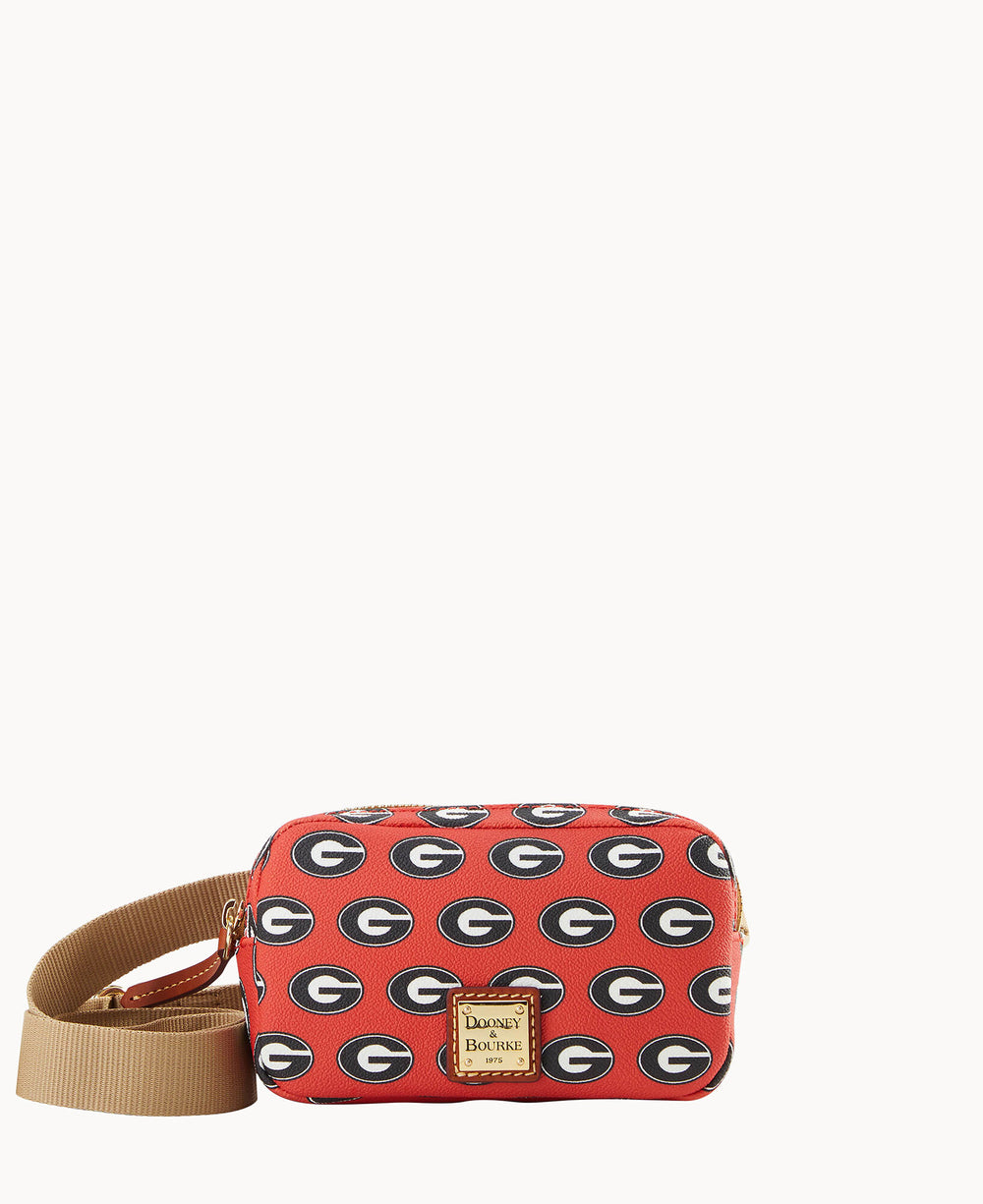 A red Dooney & Bourke crossbody bag with a tan strap, decorated with repeating black and white University of Georgia G logos.