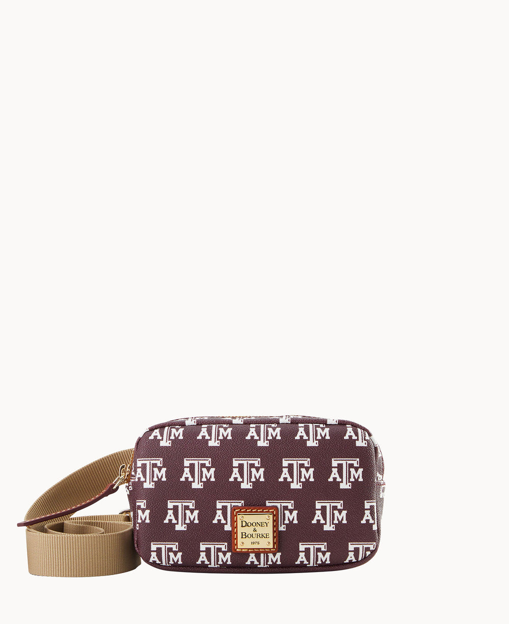 A maroon crossbody bag with a tan strap, featuring a repeating Texas A&M University logo pattern and a Dooney & Bourke label on the front.