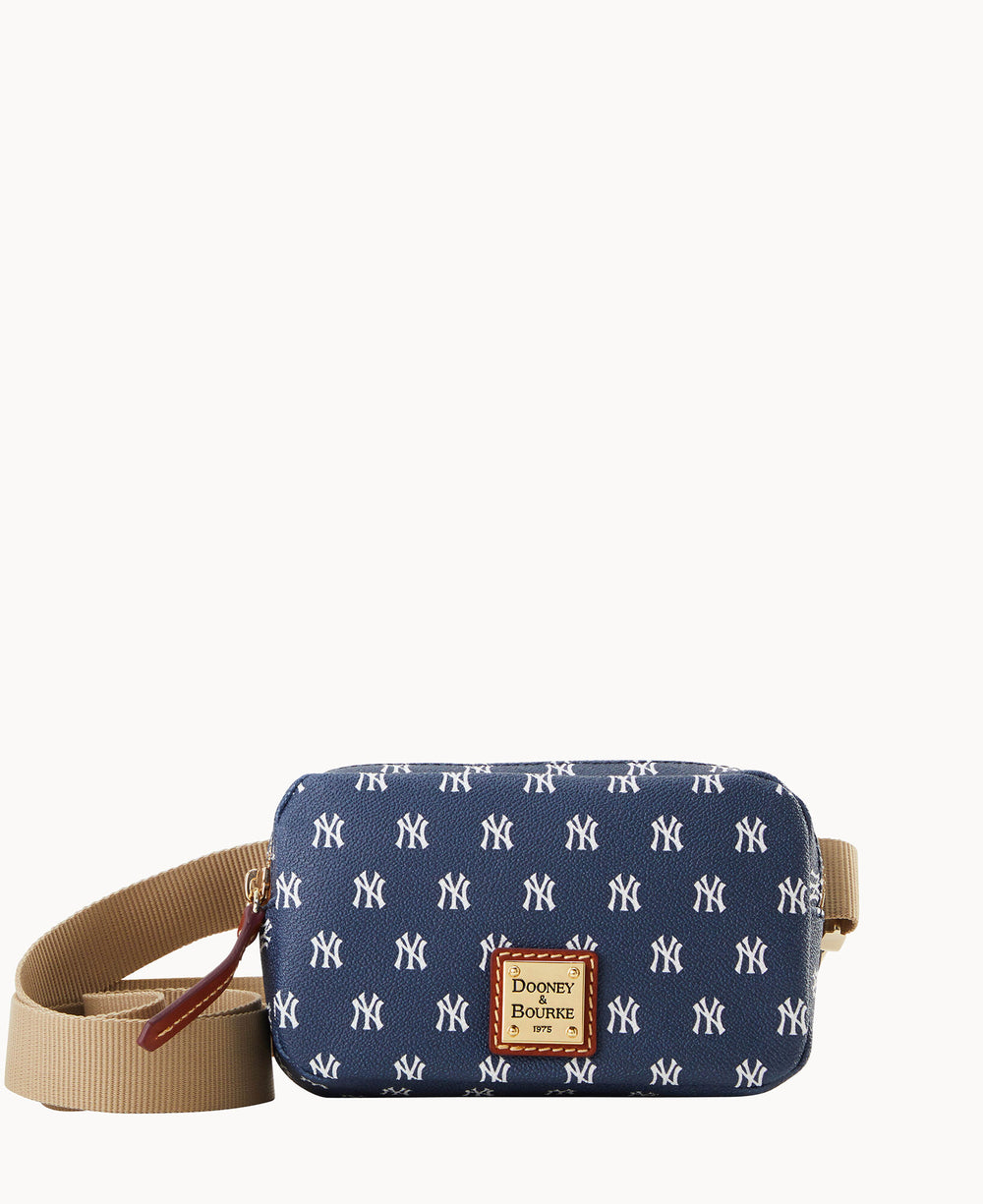 A navy blue crossbody bag with a beige adjustable strap, decorated with a repeating white NY pattern and a Dooney & Bourke logo patch on the front.