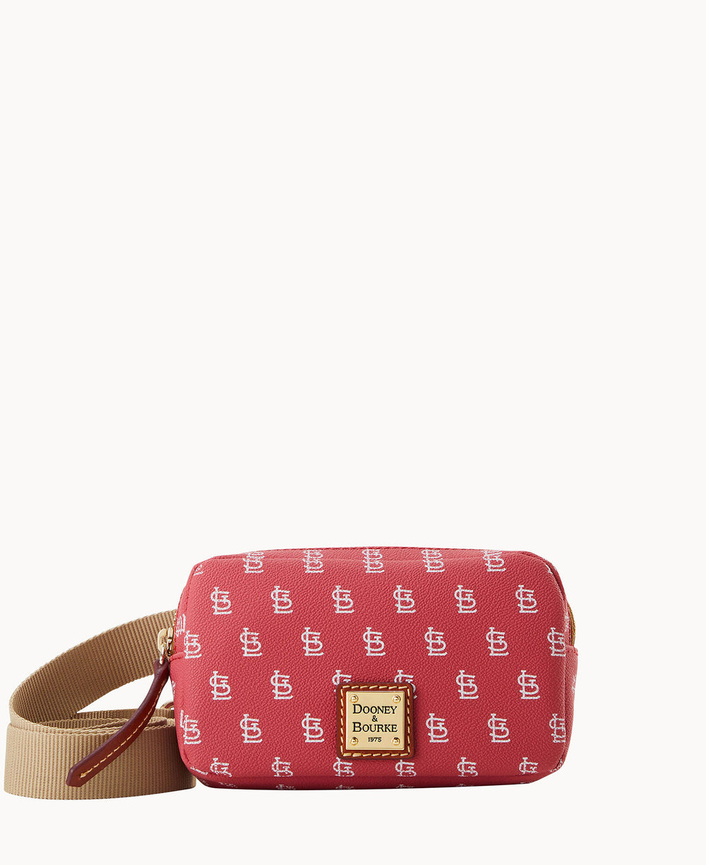 A small red crossbody bag with a beige adjustable strap, featuring a repeating white STL logo pattern and a gold Dooney & Bourke label on the front.