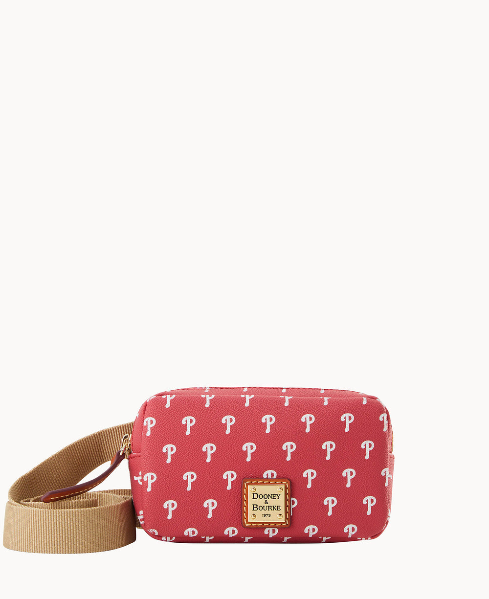 A small red crossbody bag with a tan strap, decorated with repeating white P logos and a gold Dooney & Bourke label on the front.