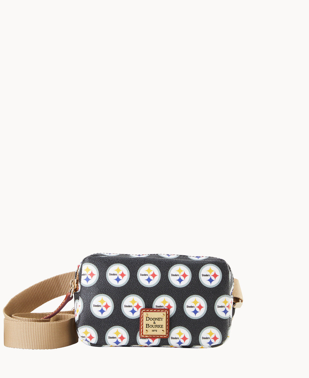 A black crossbody bag with a tan adjustable strap, featuring a repeating Pittsburgh Steelers logo pattern and a Dooney & Bourke logo patch on the front.