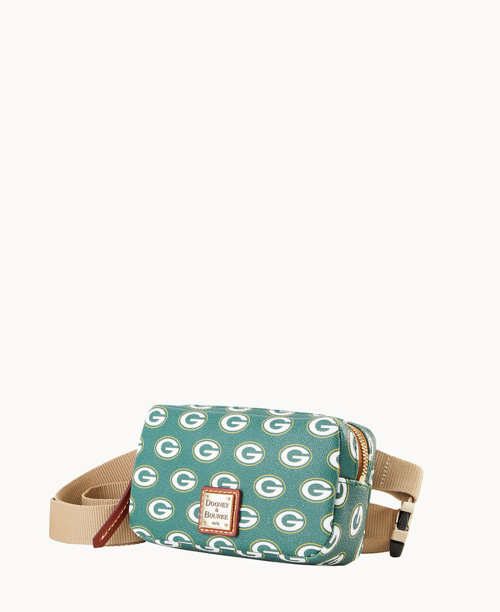 A green crossbody bag with tan strap, featuring a repeating Green Bay Packers â€œGâ€ logo pattern and a Dooney & Bourke logo patch on the front.