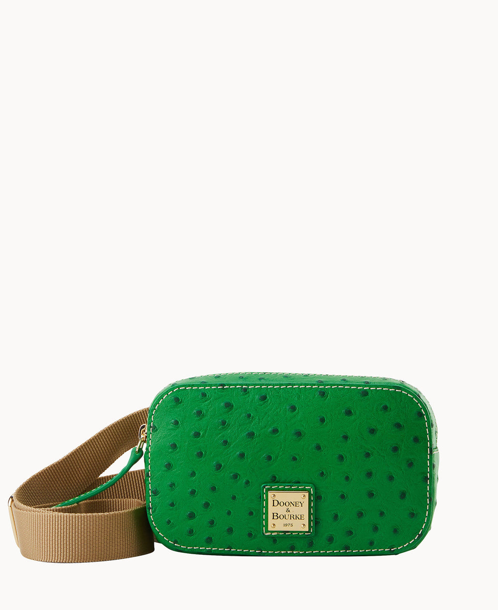 A small green crossbody bag with a textured ostrich pattern, a tan adjustable strap, and a gold rectangular Dooney & Bourke label on the front. The background is white.
