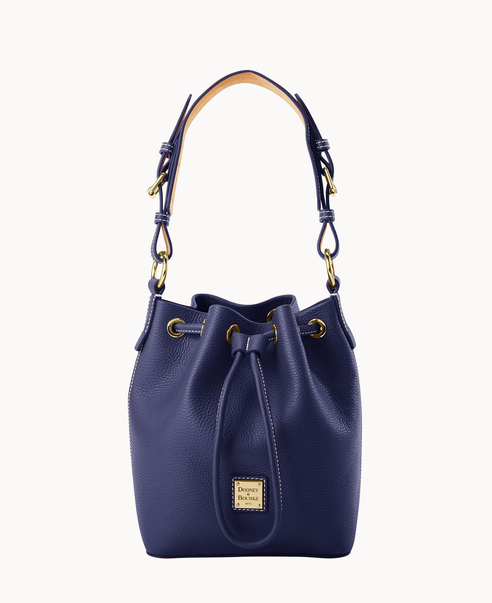 A dark blue leather bucket bag with gold hardware, a drawstring closure, and a short handle. The front features a small rectangular Dooney & Bourke logo plaque.