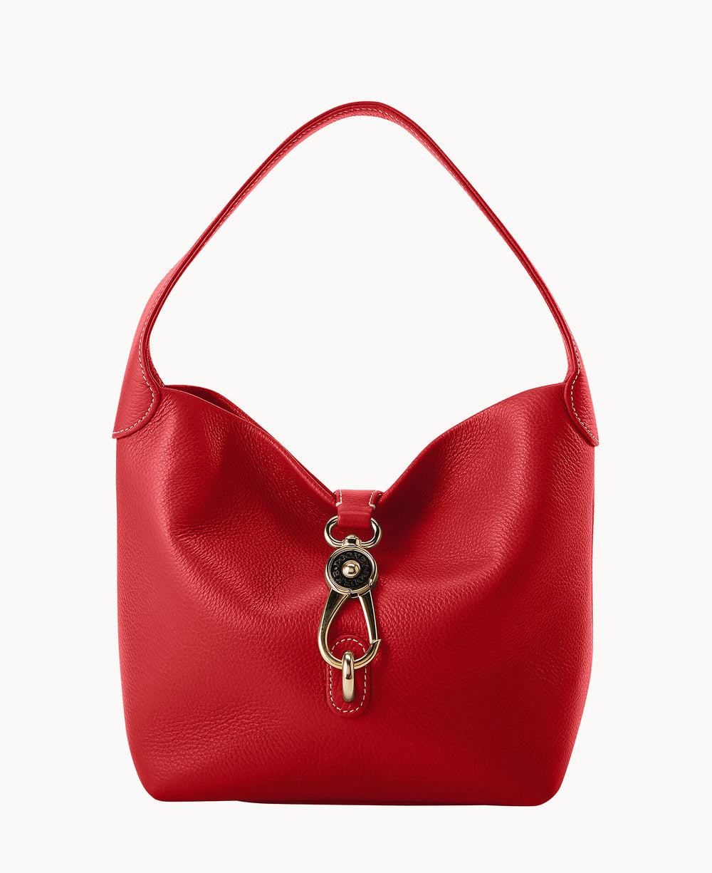 A red leather handbag with a single wide strap and a gold-tone decorative clasp on the front, set against a plain white background.