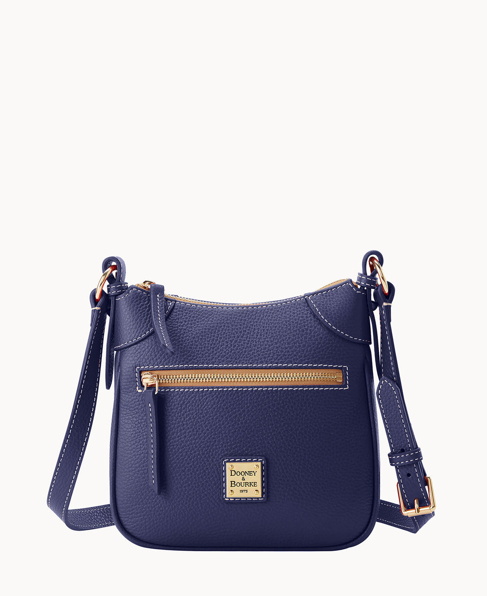 A small, navy blue leather crossbody bag with gold hardware, an adjustable strap, a front zip pocket, and a Dooney & Bourke logo patch at the bottom center.