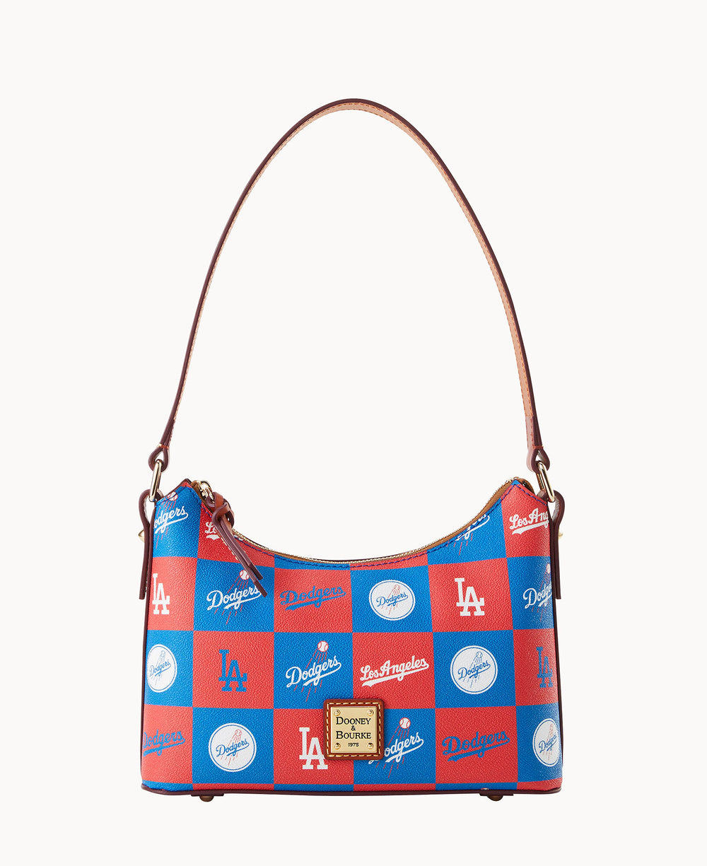 A blue and red checkered Dooney & Bourke handbag featuring Los Angeles Dodgers logos and script. The bag has a tan leather strap and gold-tone logo plate on the front.