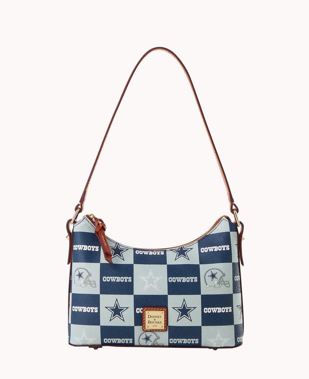 A blue and white checkered Dooney & Bourke handbag with brown leather straps, featuring Dallas Cowboys logos, stars, and the word Cowboys on the squares.