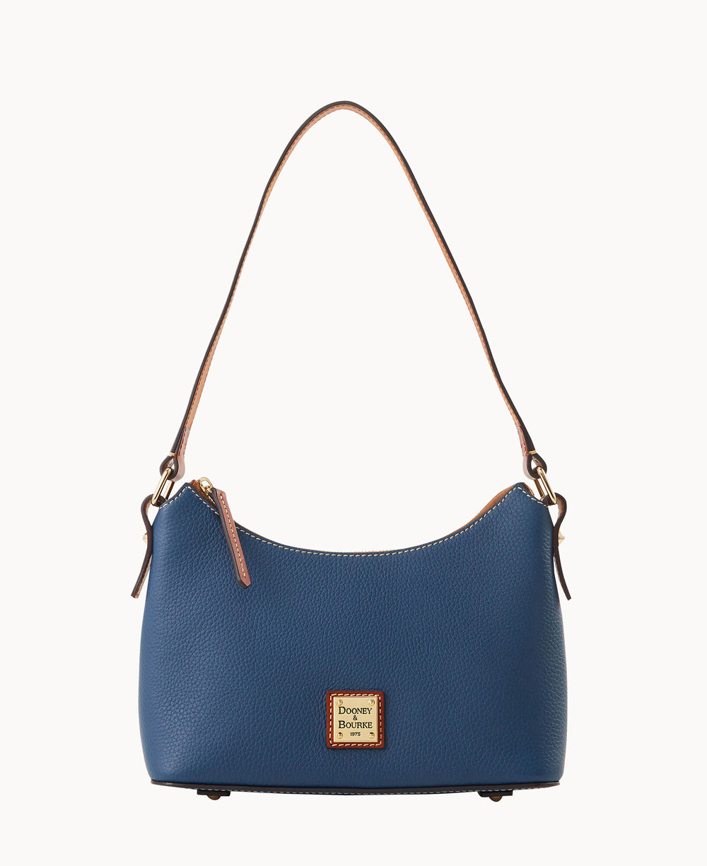 A blue leather shoulder bag with a short brown strap, gold-tone hardware, and a small rectangular Dooney & Bourke logo plaque on the front.