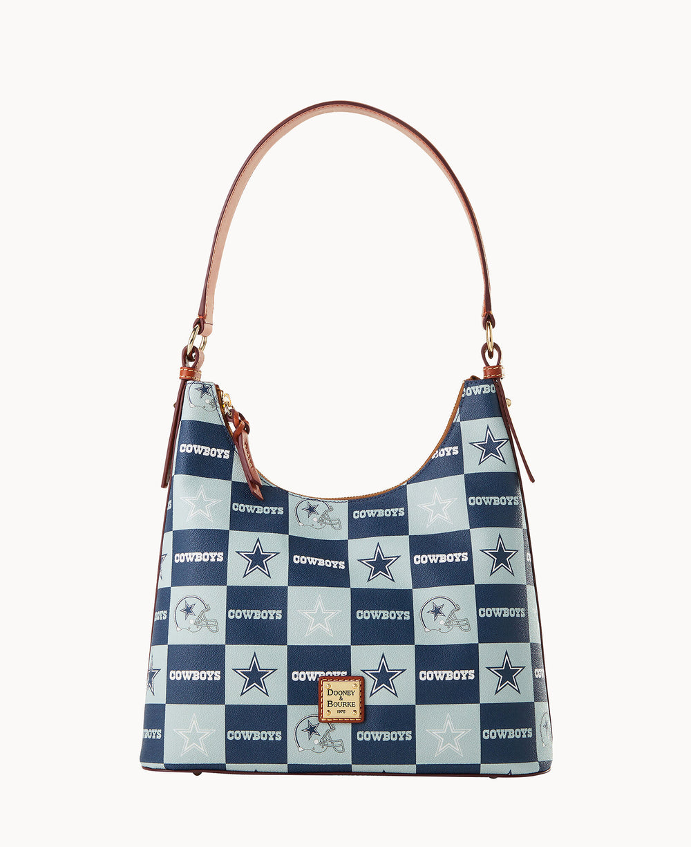 A handbag with a brown leather strap features a blue and white checkered pattern with COWBOYS text and logos. A small leather patch on the front reads Dooney & Bourke.