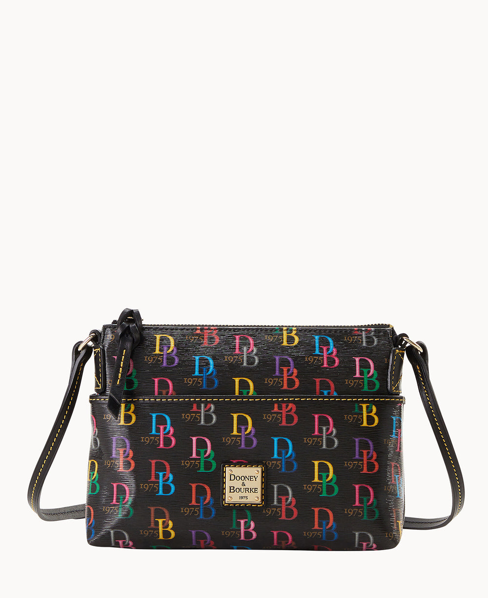 A black Dooney & Bourke crossbody bag featuring a colorful, repeating DB logo pattern, a zippered top, front pocket, adjustable strap, and a gold-tone logo patch on the front.