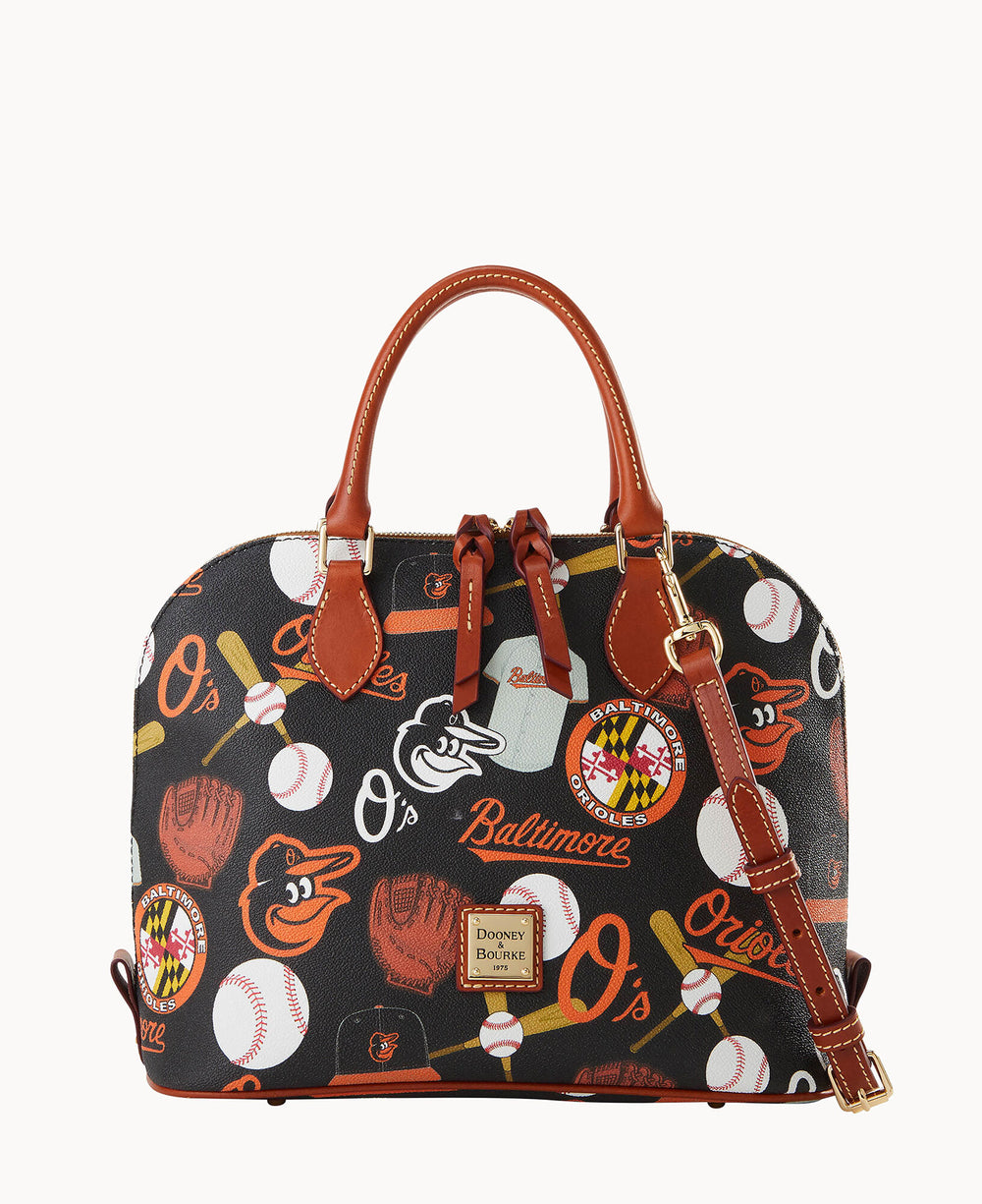 A black Dooney & Bourke handbag decorated with Baltimore Orioles baseball-themed graphics, including bats, balls, gloves, team logos, and Baltimore text. The bag has brown leather handles and an adjustable strap.