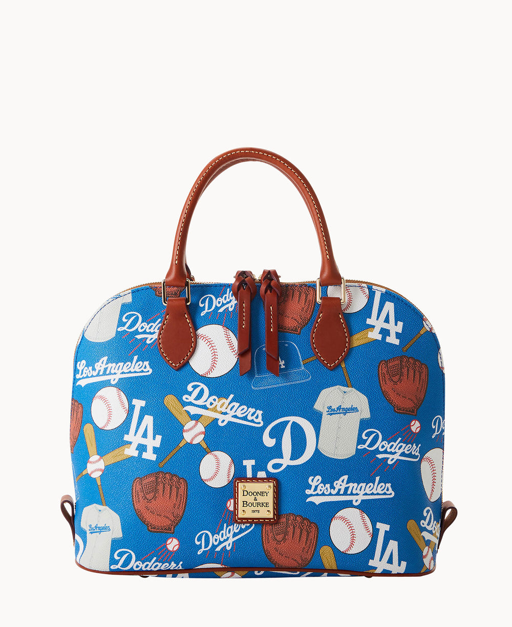 A blue Dooney & Bourke handbag with brown handles, decorated with Los Angeles Dodgers logos, baseballs, gloves, caps, and the words â€œDodgersâ€ and â€œLos Angeles.â€.