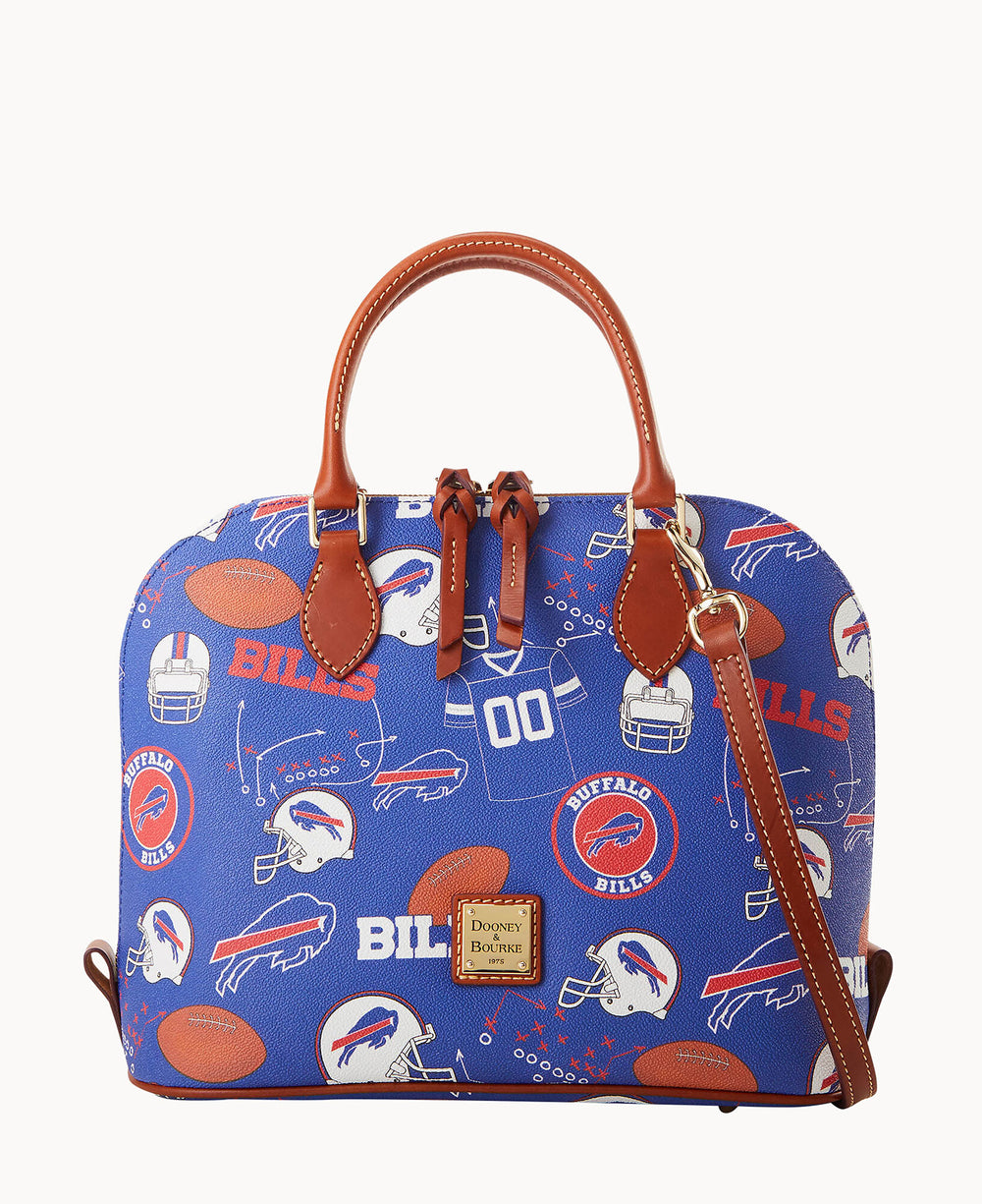 A blue Dooney & Bourke handbag featuring Buffalo Bills logos, helmets, footballs, and red text, with brown leather handles and trim, plus a detachable shoulder strap.