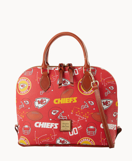 A red Dooney & Bourke handbag decorated with Kansas City Chiefs logos, footballs, helmets, and the word CHIEFS in yellow, featuring brown leather handles and trim.