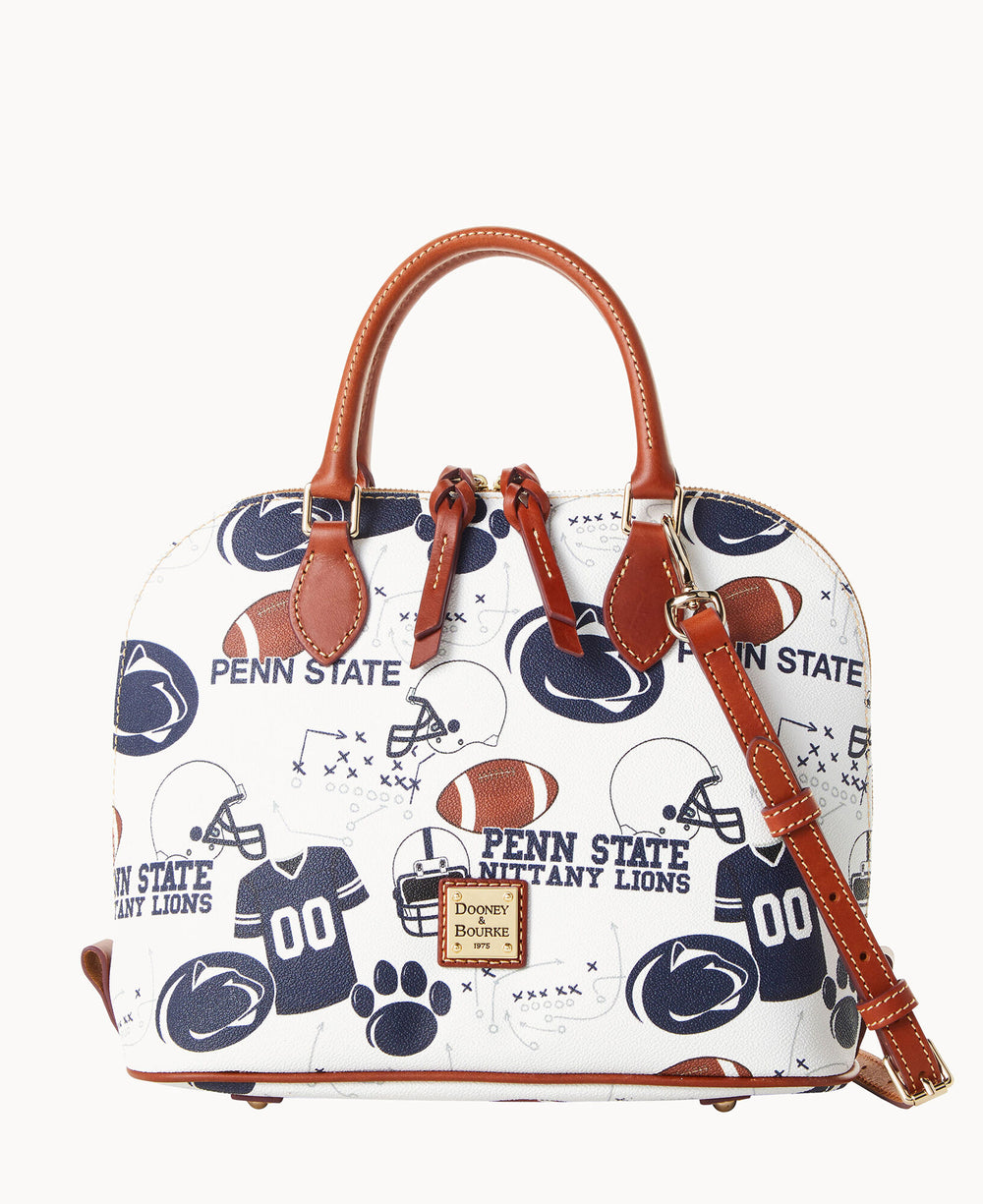 A white dome-shaped handbag with brown leather handles and strap, featuring Penn State Nittany Lions logos, football helmets, jerseys, and play diagrams in blue. The bag has Dooney & Bourke branding on the front.