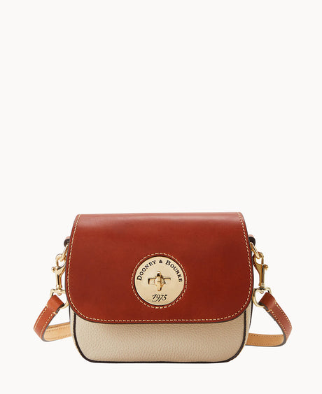 A small crossbody bag with a brown leather flap, beige body, gold hardware, and an embossed circular Dooney & Bourke 1975 logo on the front. The bag has an adjustable leather strap.