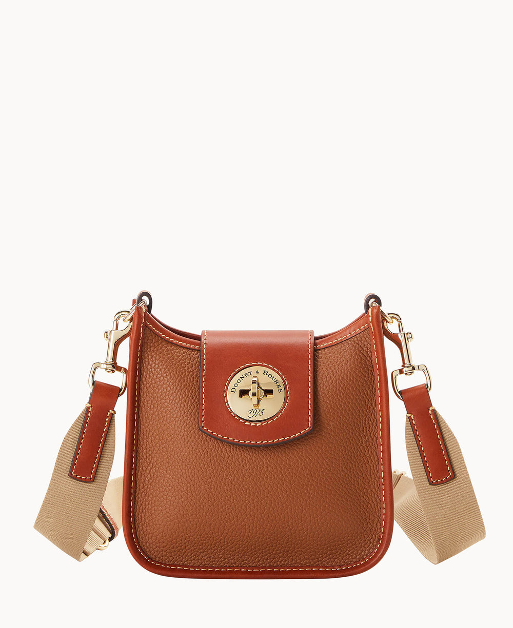 A small brown leather crossbody bag with tan accents, a wide beige fabric strap, and a gold circular logo plate on the front flap. The bag features white stitching and gold-tone hardware.