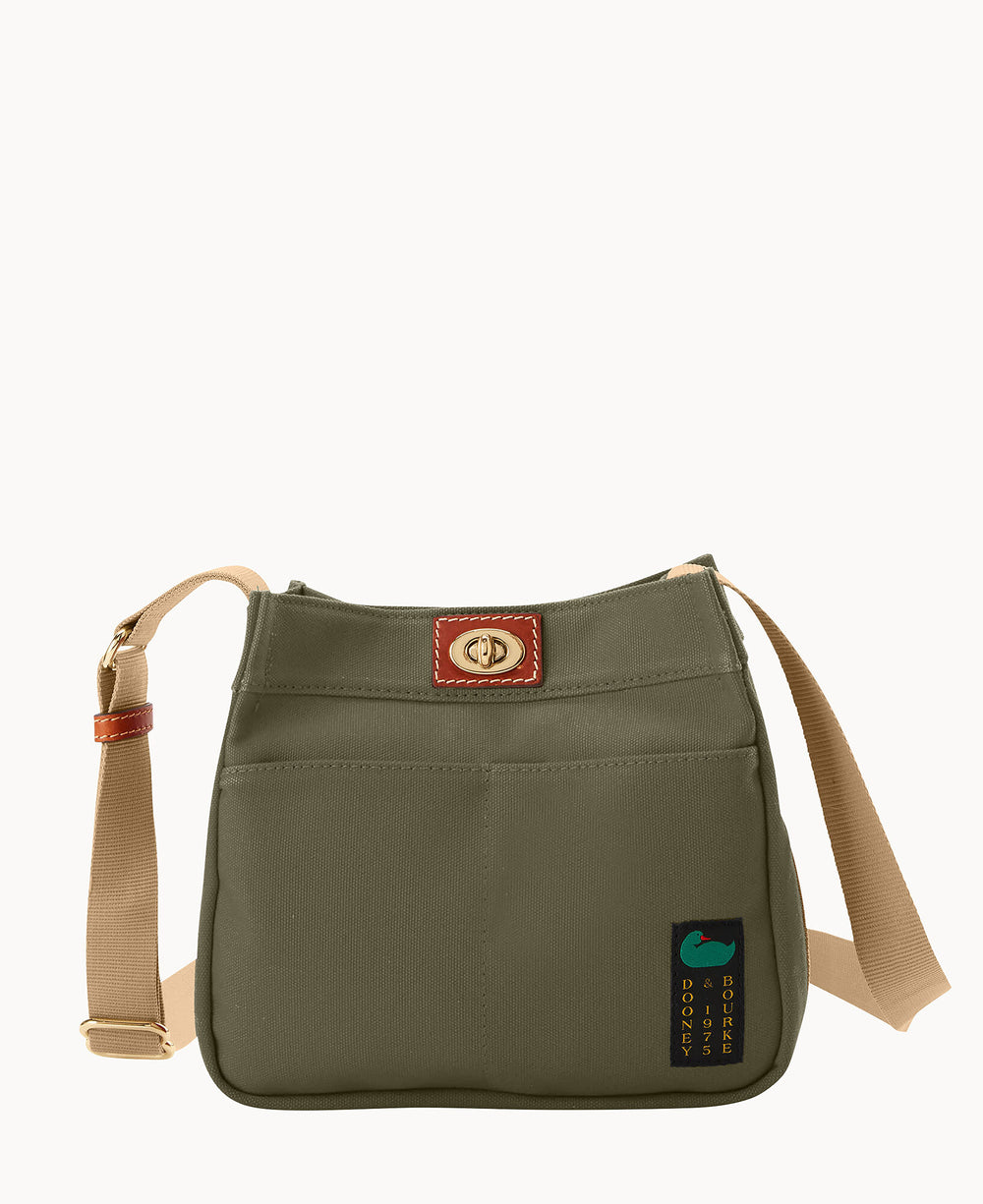 A green shoulder bag with a beige adjustable strap, a gold clasp on a brown leather accent, front pockets, and a small patch with a green duck and text near the bottom corner.