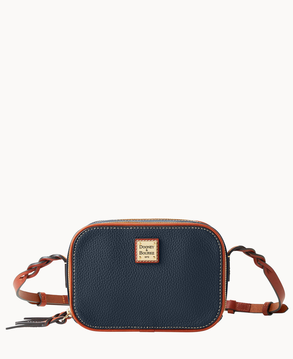 A small navy blue crossbody bag with brown leather trim, braided leather strap, and a gold square Dooney & Bourke logo plate on the front.